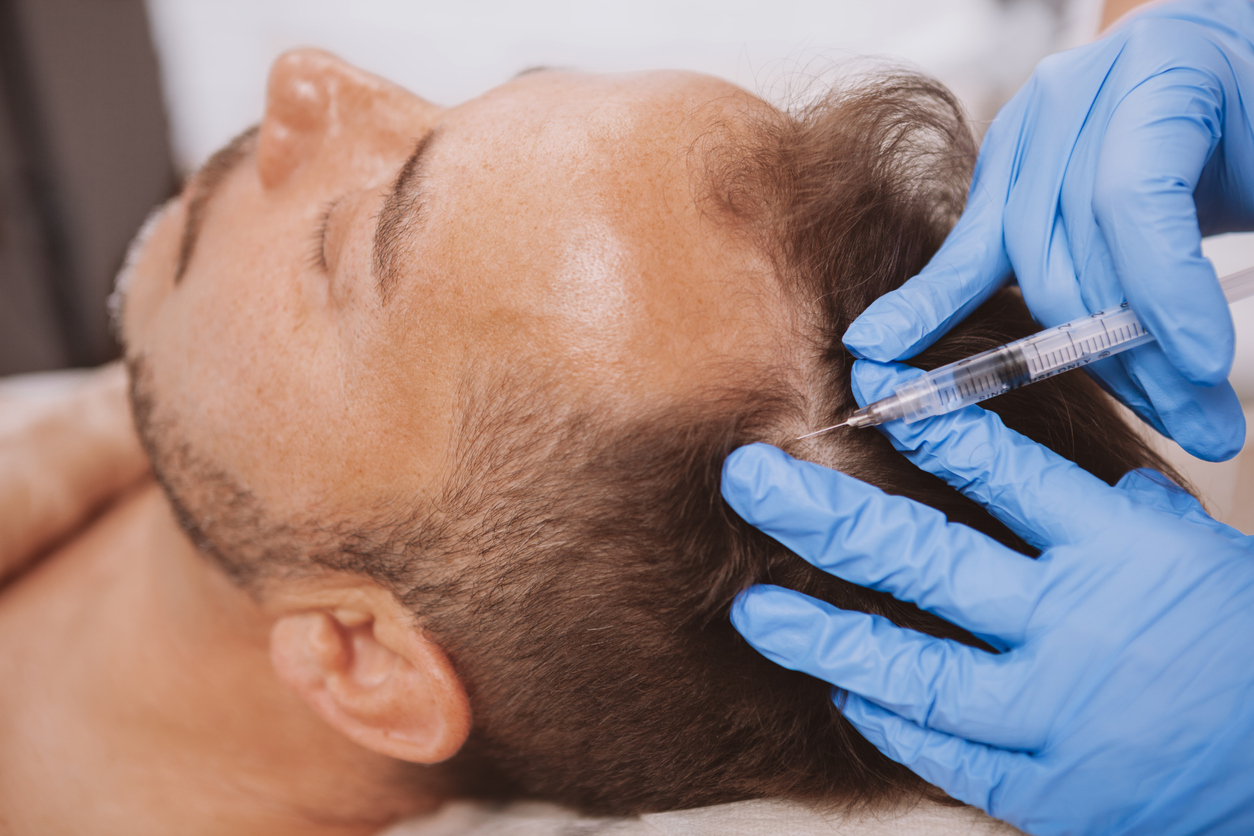 Mature man getting facial skincare treatment at spa beauty salon