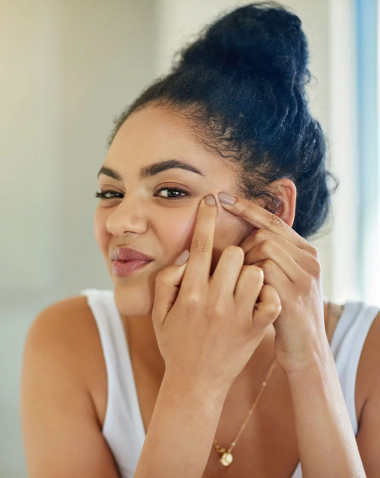 Woman popping a pimple on her face | Laser Acne treatments in Boise